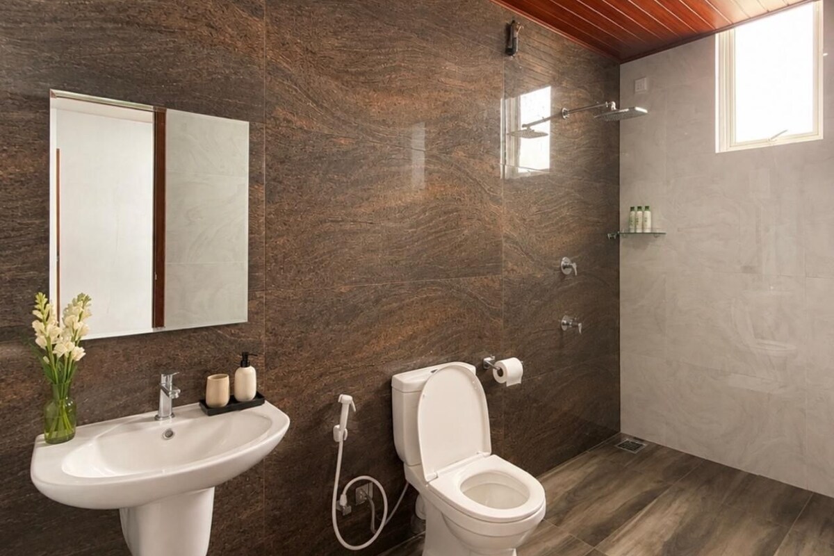 A bathroom with a sink, toilet, and shower.