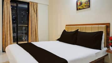 A hotel room with a bed, a nightstand, a painting on the wall, and a view through the window.