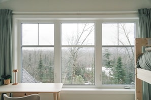 A room with a large window, a desk, and a bunk bed. - Beautiful Muskoka Cottage with Games, BBQ & Views (Huntsville)
