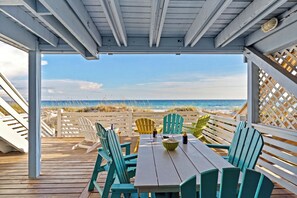 A wooden deck with a table and chairs overlooking a beach. - Beachfront + Private Beach + Chair Service + 3 Decks | Gulf Views | Seawinds 1 (Miramar Beach)
