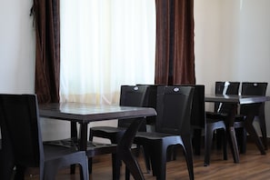 A dining area with a rectangular table and six chairs.