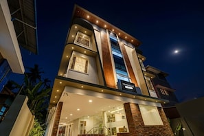 A multi-story building with a prominent 'TOWNHOUSE' sign, large windows, and a modern architectural design.