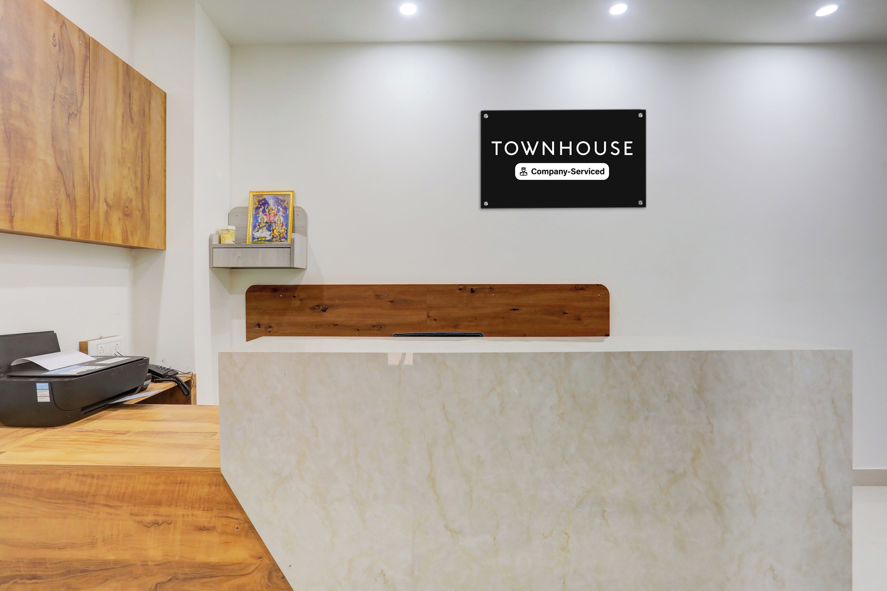A reception desk with a sign indicating it is a company-serviced location.