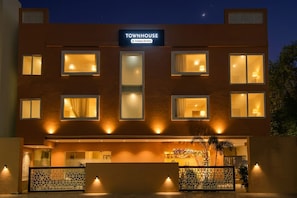 A modern building with a sign reading 'TOWNHOUSE Company-Serviced'. - Super Townhouse Viraj Khand (Lucknow)