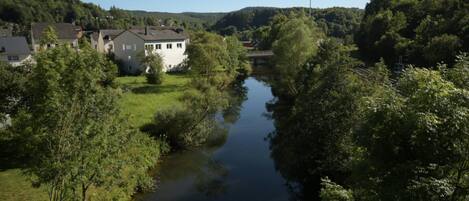 A river flowing through a residential area with houses on both sides.