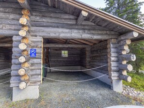 A log cabin with a gravel driveway and a chain-link fence. - Honka 1a by Interhome (Kuusamo)