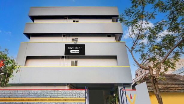 A multi-story building with a sign indicating it is a serviced company property.