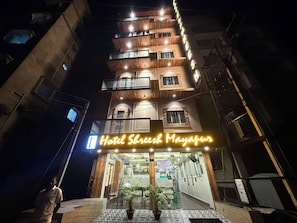 A multi-story hotel with a neon sign reading 'Hotel Shreshth Mayapur.' - HOTEL SHREESH MAYAPUR (Krishnanagar)