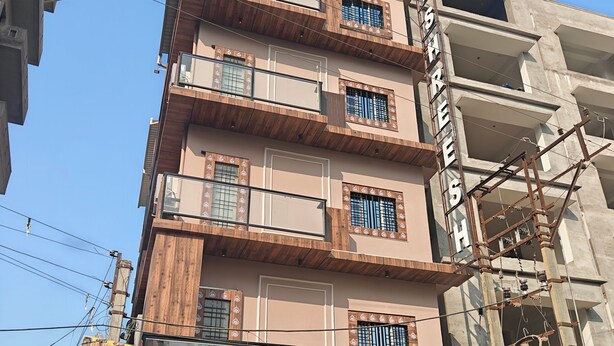 A multi-story building with a sign indicating it is a hotel.