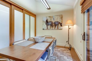 A dining area with a wooden table, chairs, a woven basket, and a painting of horses on the wall. - 2 Mi to Sun Valley Resort! Upscale Mtn-View Home (Ketchum)