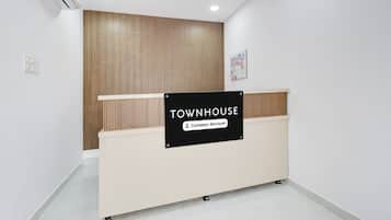 A reception desk with a sign indicating it is a company-serviced area.