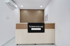 A reception desk with a sign that reads 'TOWNHOUSE Company-Serviced.' - Townhouse B N Reddy Capitol Stay Inn (Hyderabad)