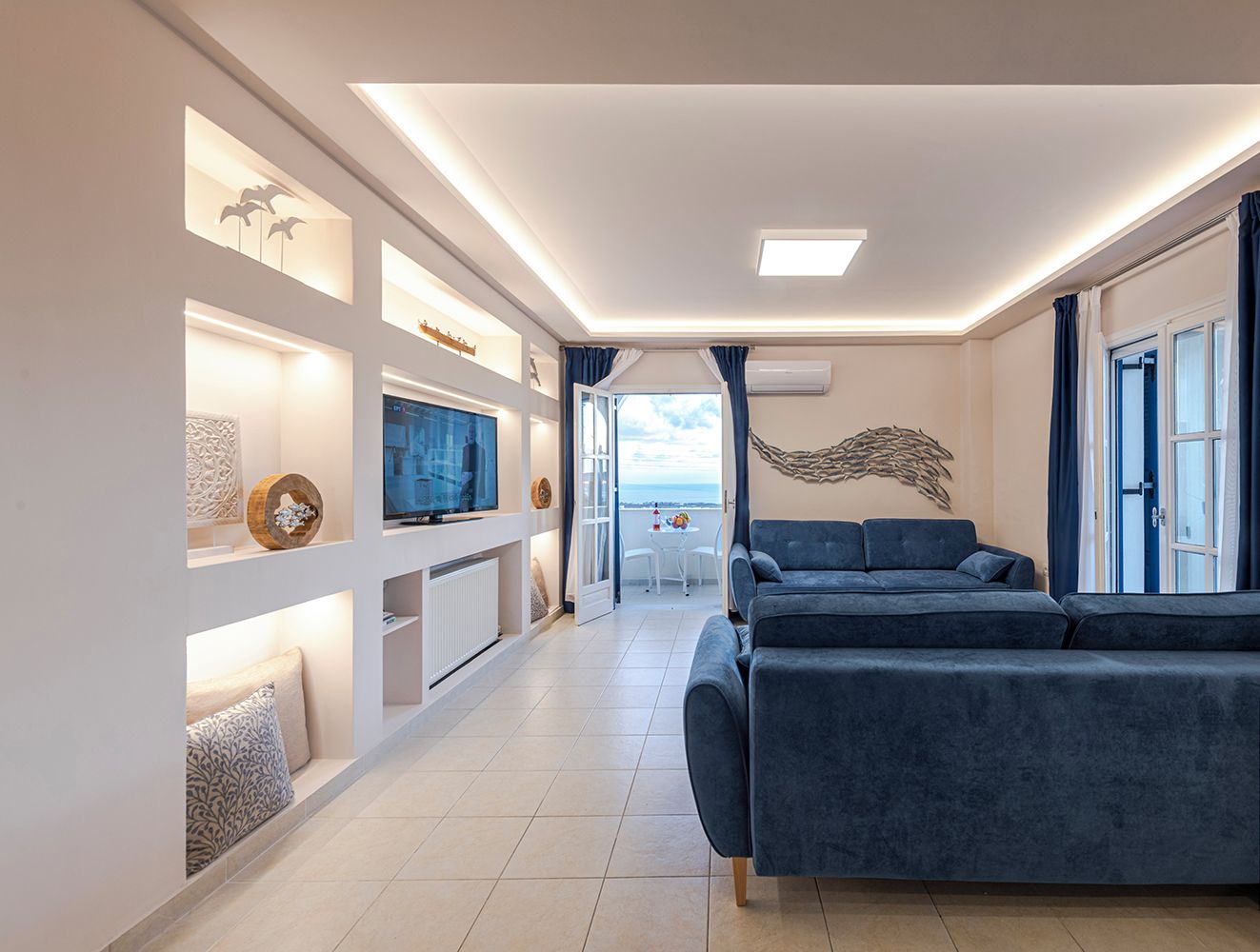 Air-conditioned living room with two big comfortable sofa beds.