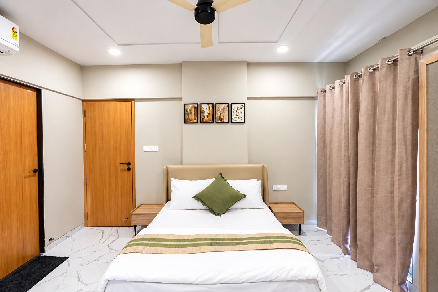 A bedroom with a bed, nightstands, a ceiling fan, and a window with curtains.