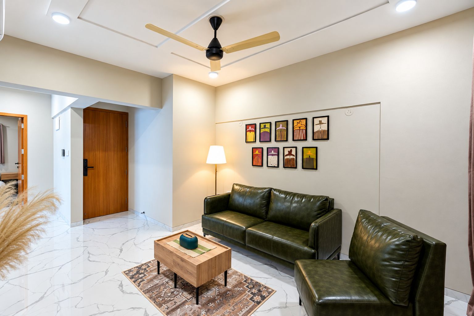 A modern living room with a leather sofa, a wooden coffee table, and a ceiling fan.