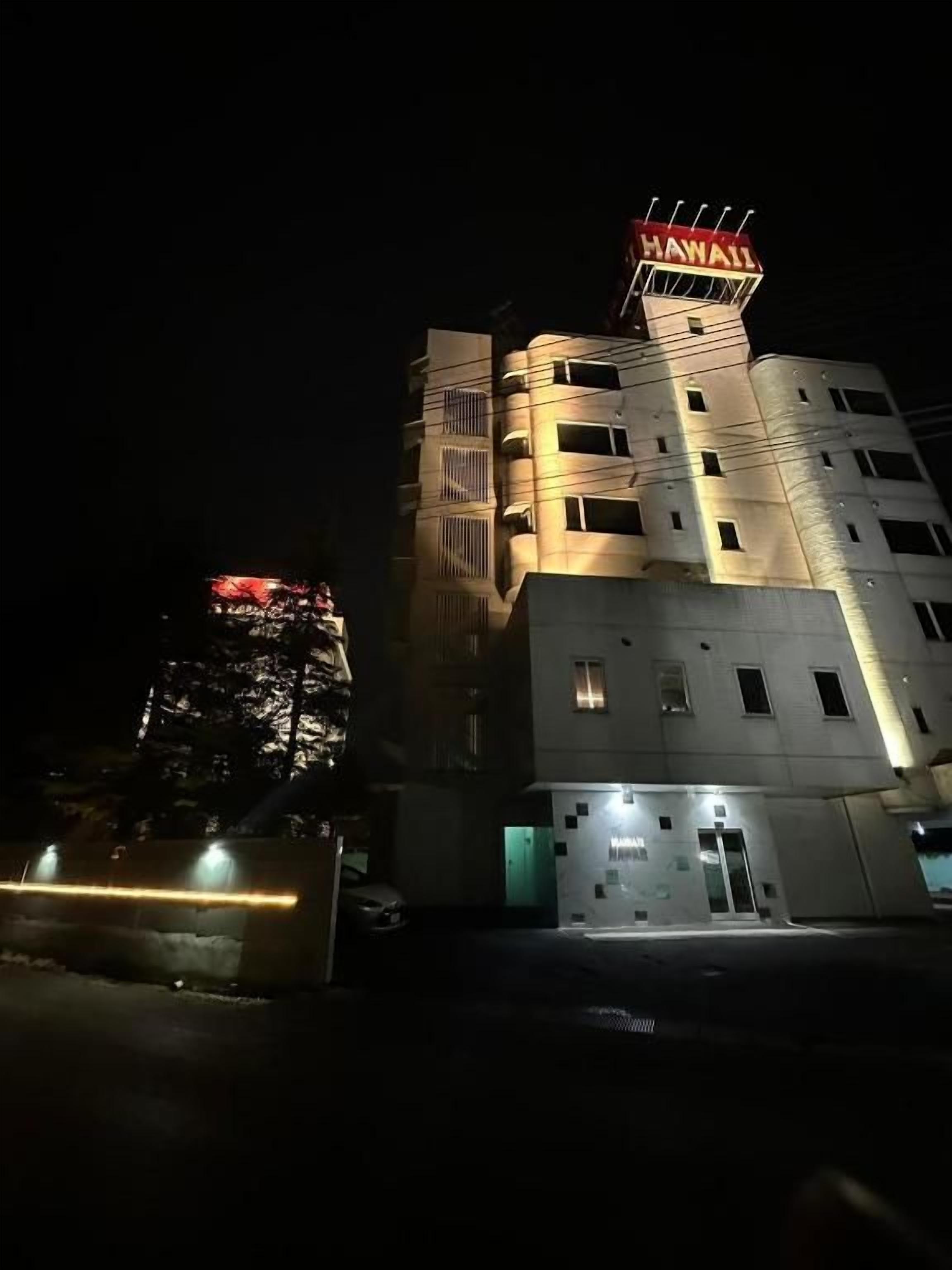 A multi-story building with a prominent sign at the top.