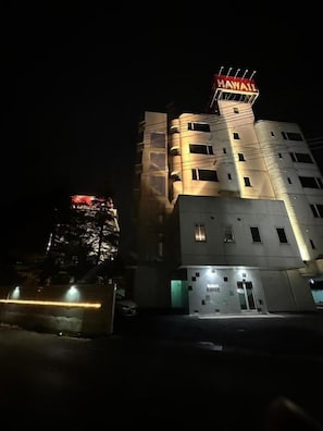 A multi-story building with a prominent sign at the top.