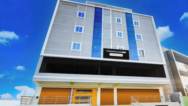 A multi-story building with a sign indicating it is a company-serviced townhouse. - Townhouse Oak LB Nagar Metro Station (Hyderabad)