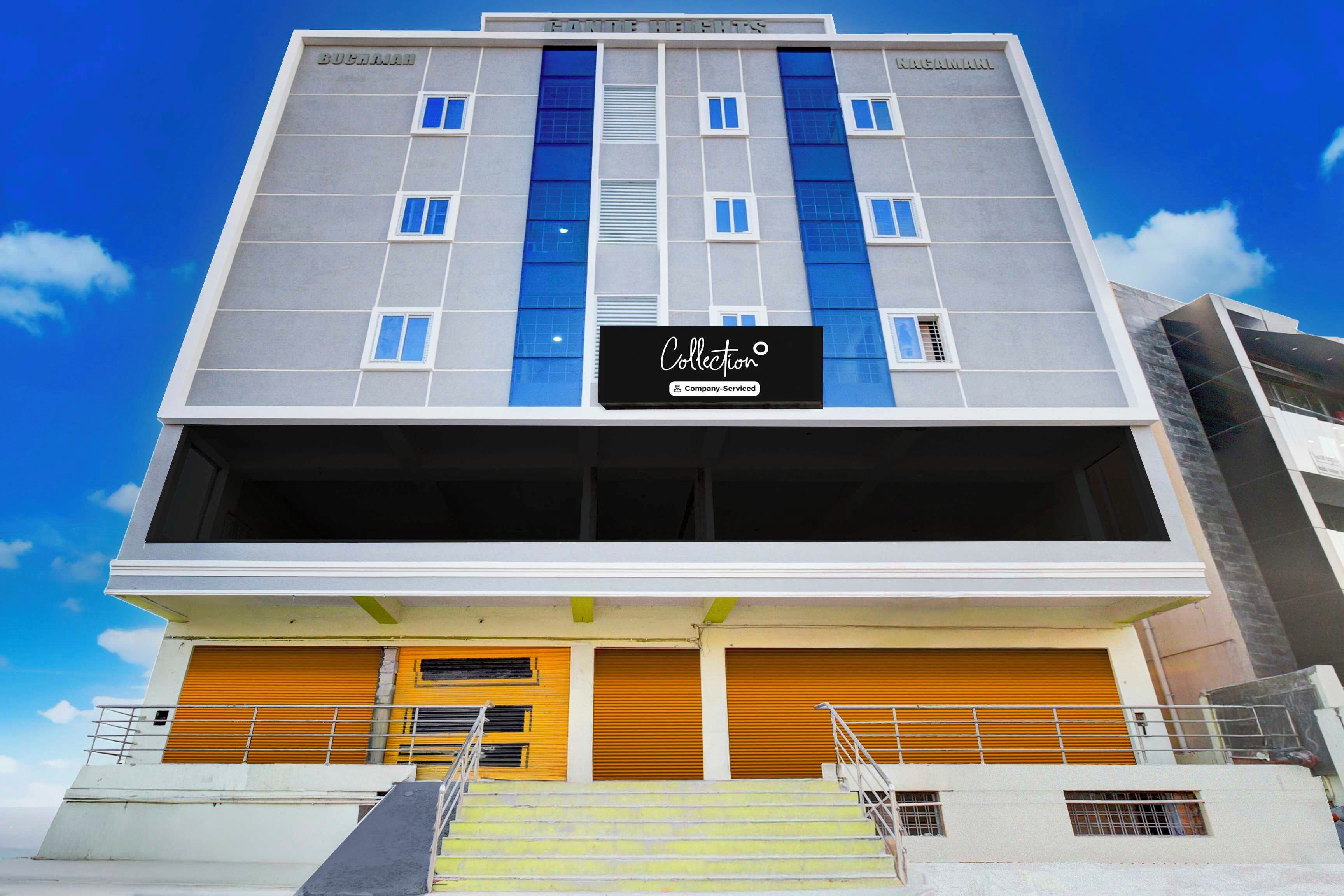 A multi-story building with a flat facade, large windows, and a sign indicating it is a company-serviced collection.