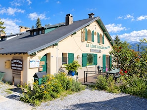 A building with a sign reading 'LE LOGIS CATALAN' indicating a location for vacation rentals.