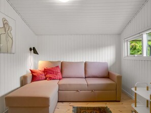 A modern living room with a sofa, a small table, and a window. - "Verner" - 1.6km from the sea by Interhome (Blokhus)