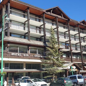 A multi-story hotel with balconies, a restaurant, and a visible street view. - La Brunerie (Les Deux Alpes)