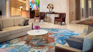 A spacious lobby with a reception desk, seating area, and a large chandelier. - Intercontinental Residence Jakarta Pondok Indah (Jakarta)