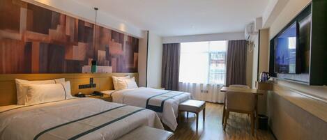 A hotel room with two beds, a desk, a television, and a large window.