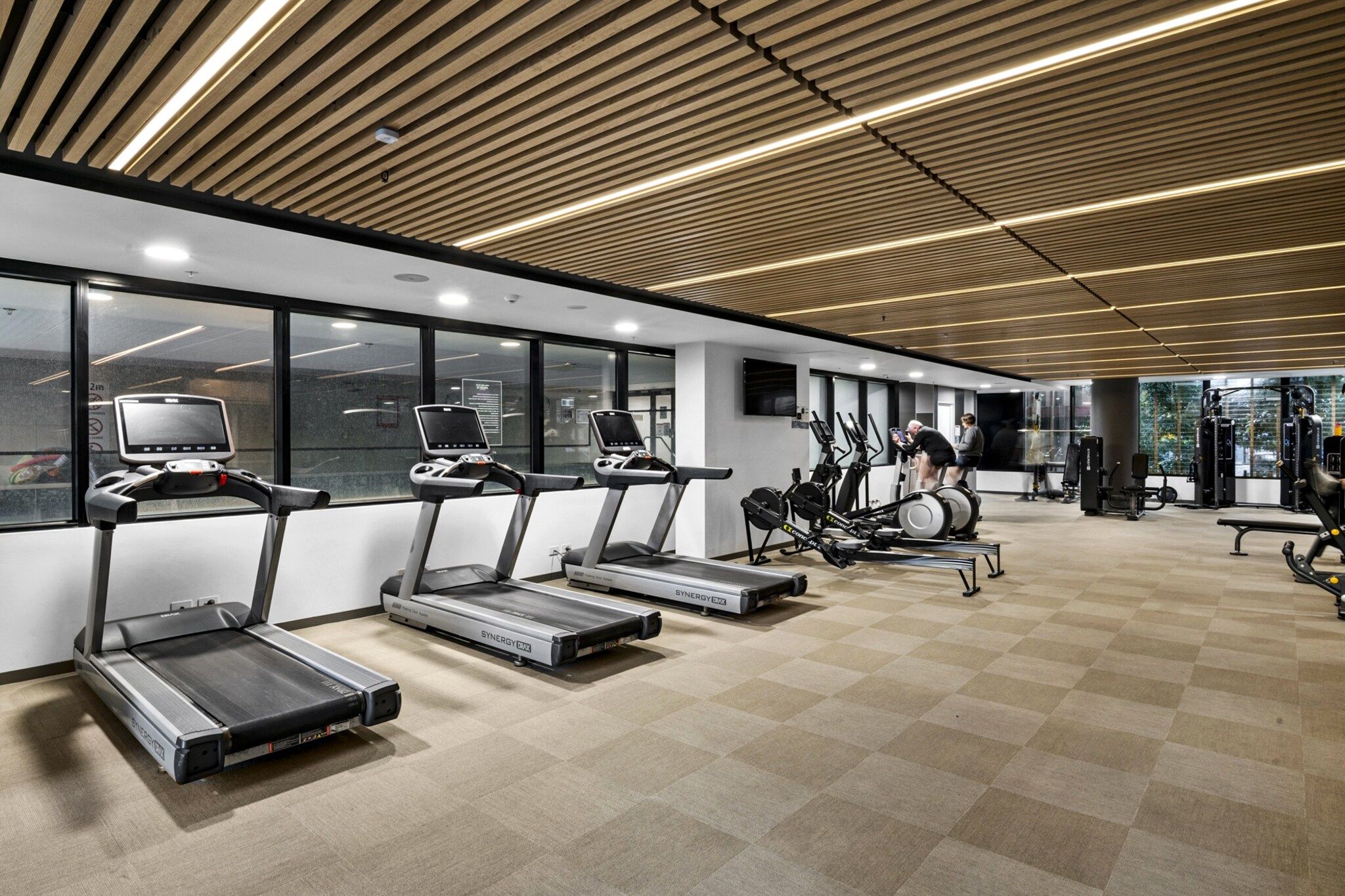 A gym with treadmills, stationary bikes, and weight machines.