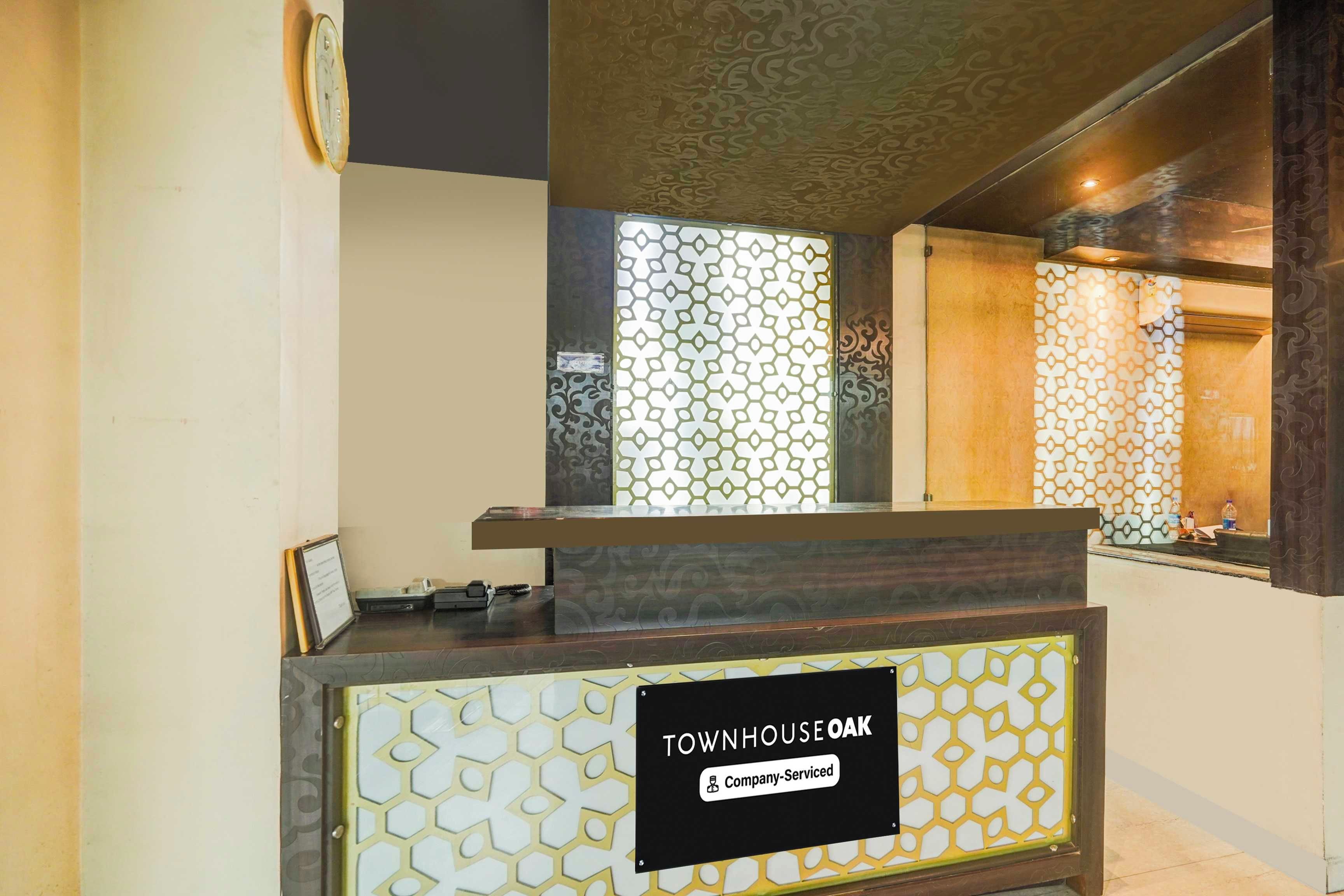 A reception desk with a sign indicating 'Townhouse Oak' and 'Company-Serviced'.