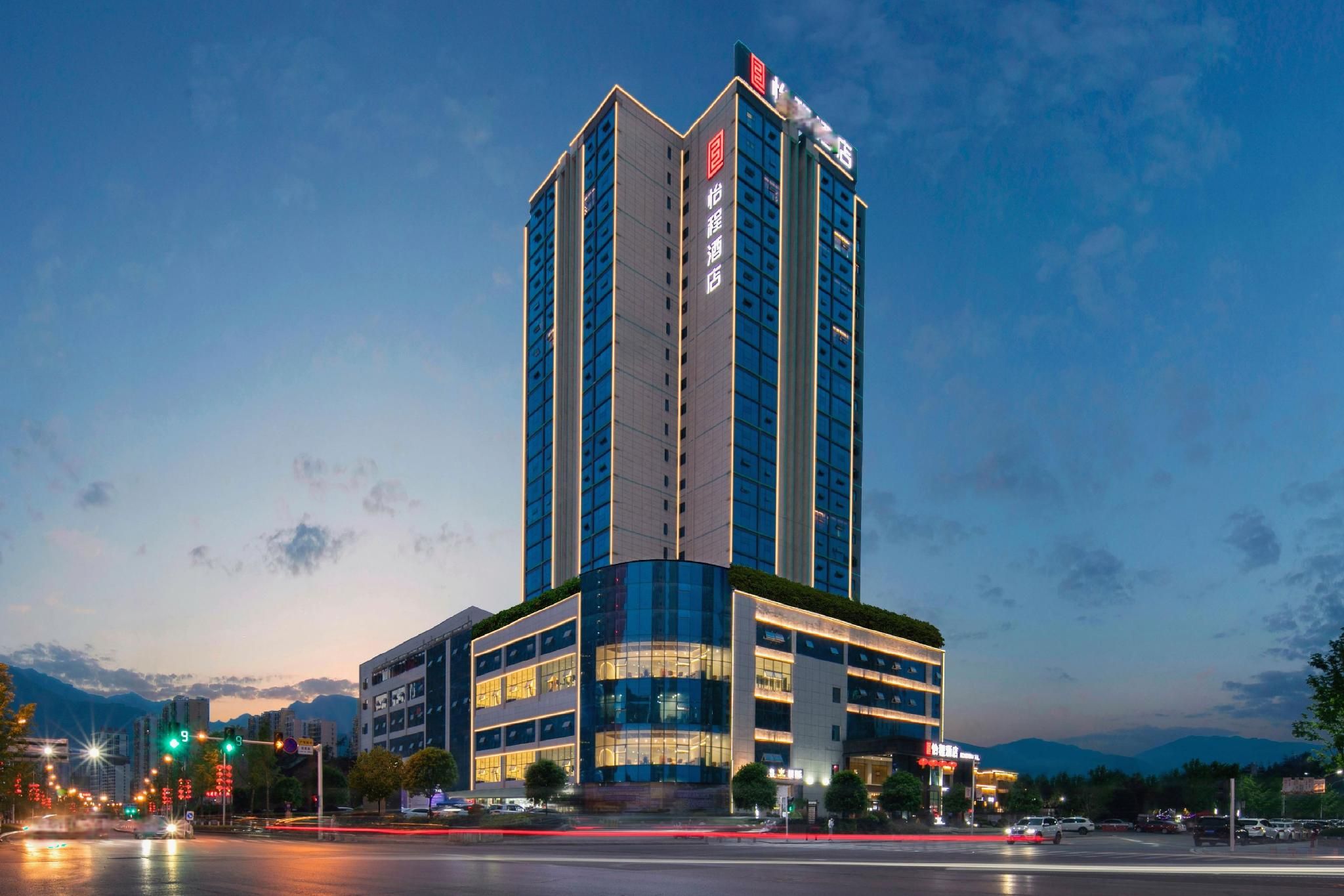 A multi-story hotel with a prominent vertical design, featuring a mix of glass and solid facade elements.