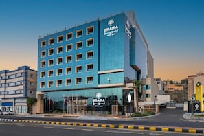 A modern hotel with a blue facade, multiple floors, and a prominent entrance. - Braira Abha Hotel (Abha)