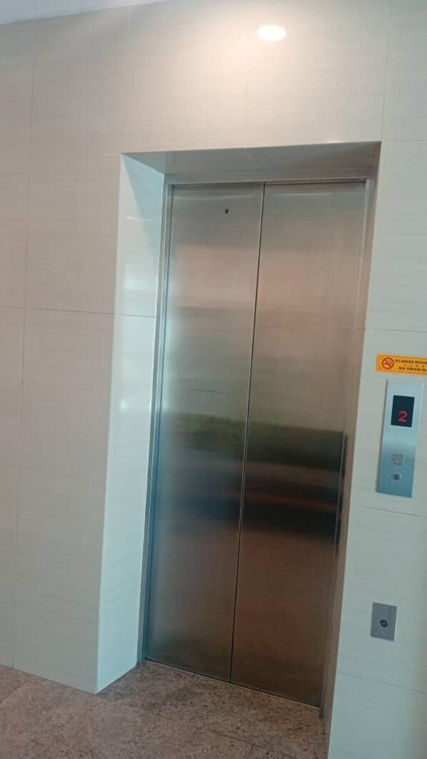 A metallic elevator door with a control panel on the wall. - Ibilik Hotel @ Johor Bahru (Johor Bahru)