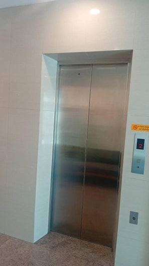 A metallic elevator door with a control panel on the wall. - Ibilik Hotel @ Johor Bahru (Johor Bahru)