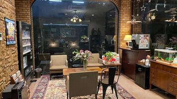 A cozy interior with a sofa, a dining table, and a kitchen area.