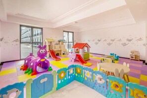 A children's play area with a slide, playhouse, and various toys.