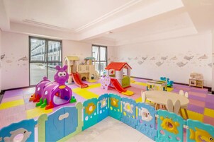 A children's play area with a slide, playhouse, and various toys.