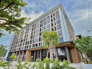 A modern building with a flat facade, multiple windows, and a central entrance. - Rangsit Residence & Hotel (Thanyaburi)