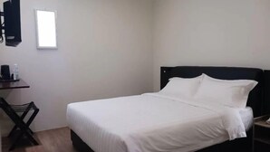 A single bed with white bedding in a room with a wooden floor and a black headboard. - Soho Tabuan Hotel Kuching (Kuching)