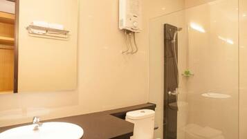A bathroom with a sink, toilet, and shower.