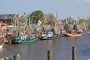 A harbor with multiple fishing boats docked. - Lüttje Huus an d" Kark (Krummhörn)