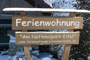A wooden sign with 'Ferienwohnung' and 'Am Nationalpark Eifel' written on it, indicating a vacation rental in the Eifel National Park. - at the Eifel National Park (Nideggen)