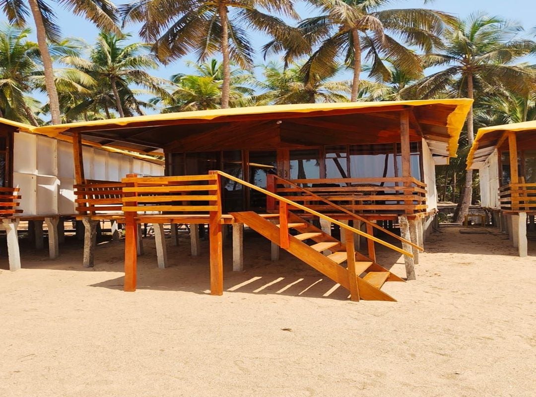 A beachside structure with wooden benches and a staircase.