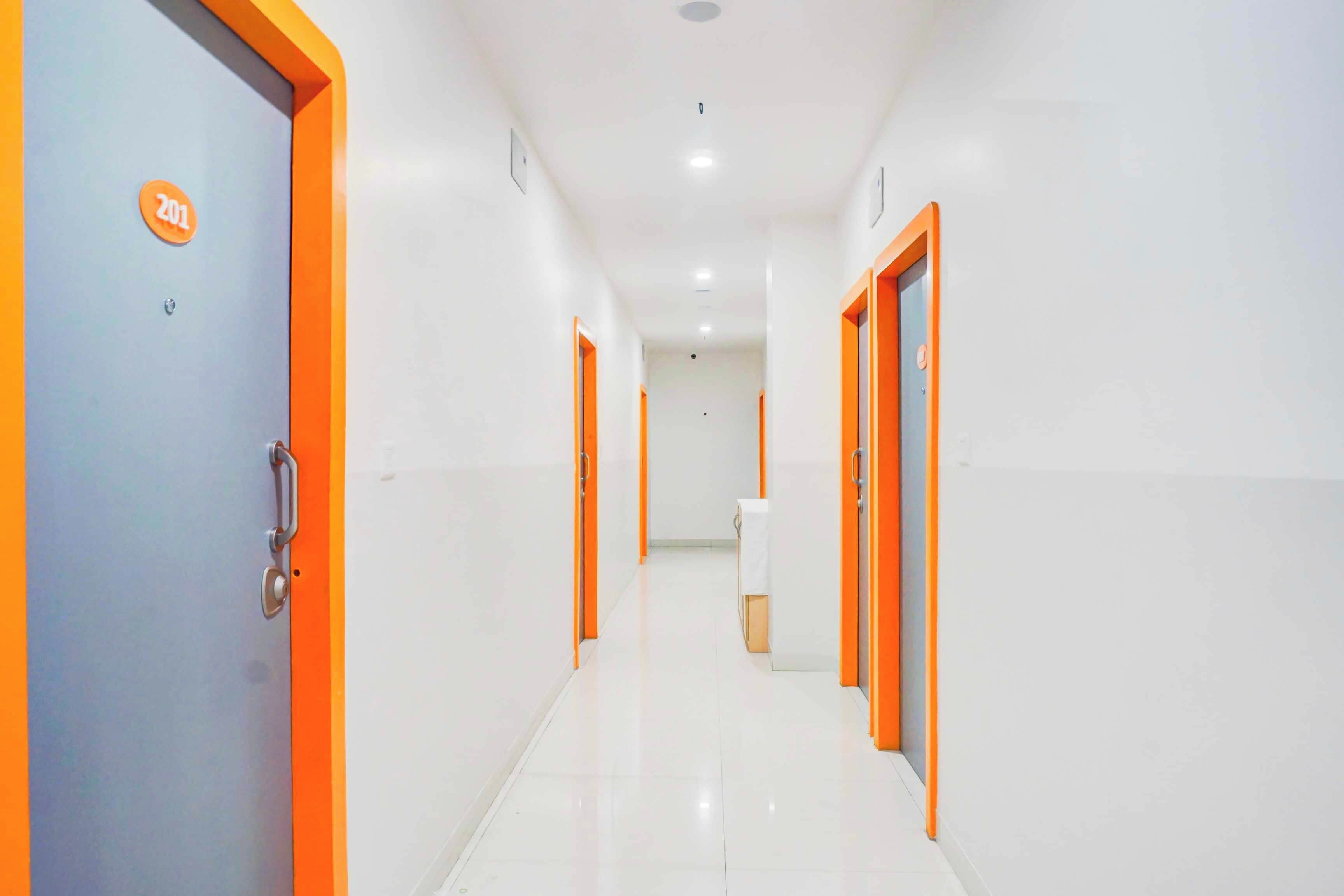 A corridor with doors on both sides, each marked with a number.