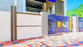 A modern building entrance with a patterned floor and a blue and yellow gate.