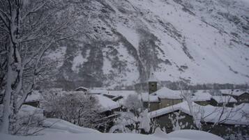 A snow-covered mountain with buildings at its base.