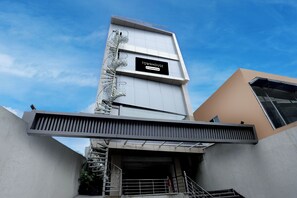 A modern building with a prominent sign reading 'TOWNHOUSE'.