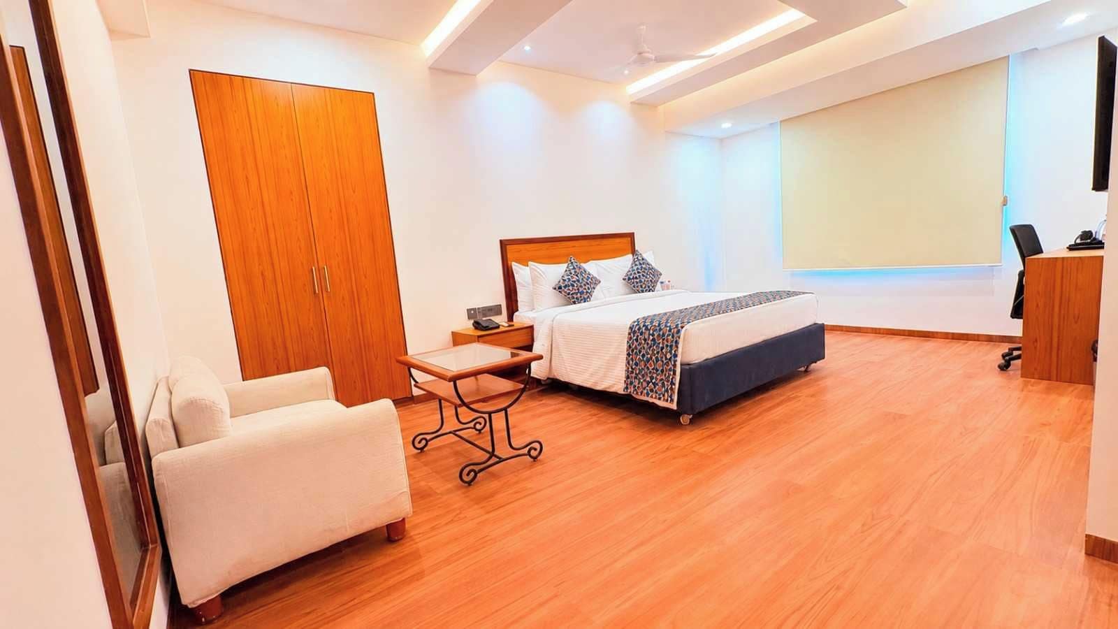 A modern bedroom with a bed, bedside table, and a wardrobe.