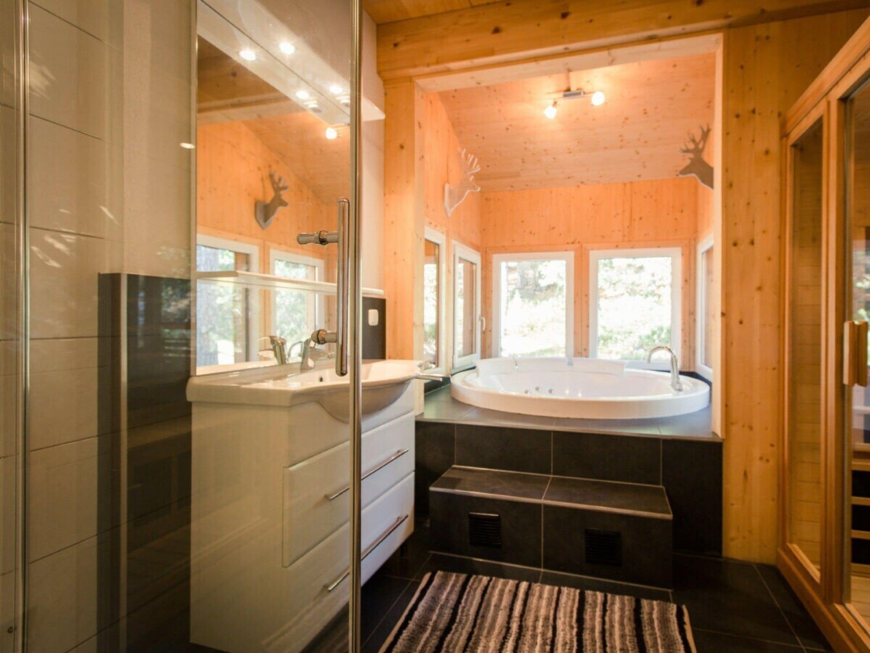 A modern bathroom with a large bathtub, a separate shower area, and a glass-enclosed shower.