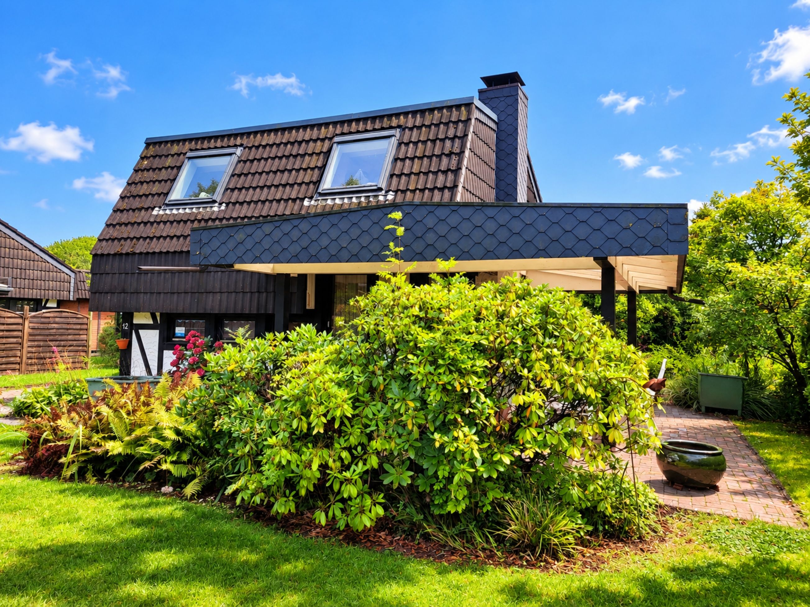 A modern house with a sloped roof, two windows, and a covered porch.